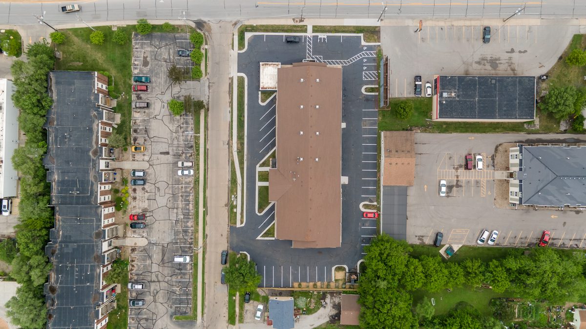 Aerial view straight down on the building and the parking lot that wraps it.